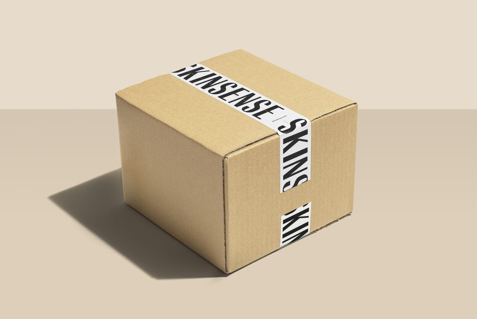 Single cardboard box sealed with striped white packing tape wrap